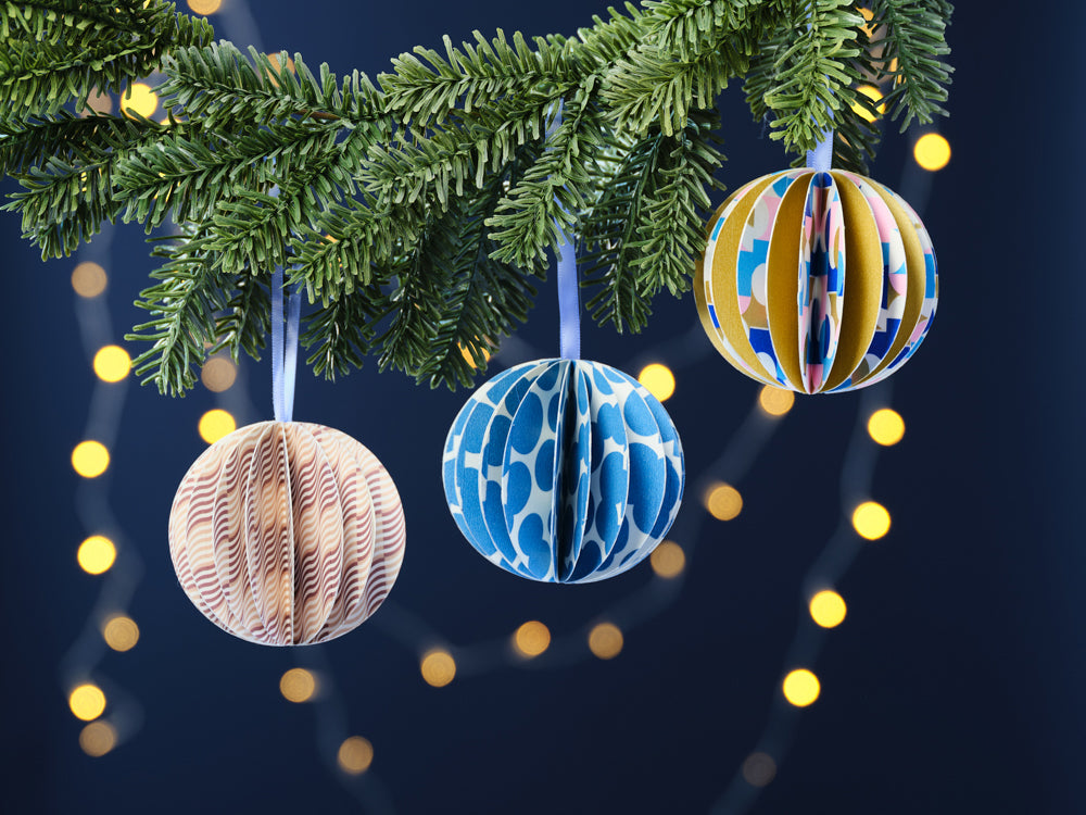 handmade washi tape Christmas baubles hanging on tree.